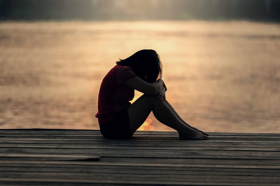 depressed teen on dock