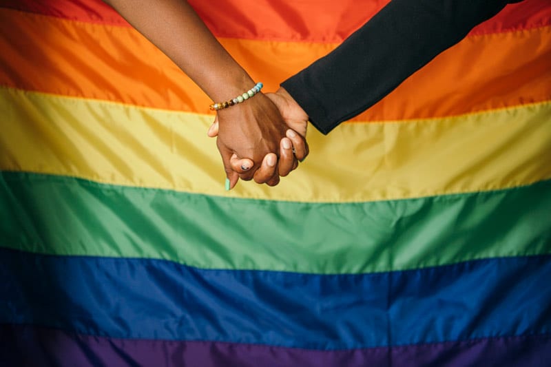 lgbtq hands over flag