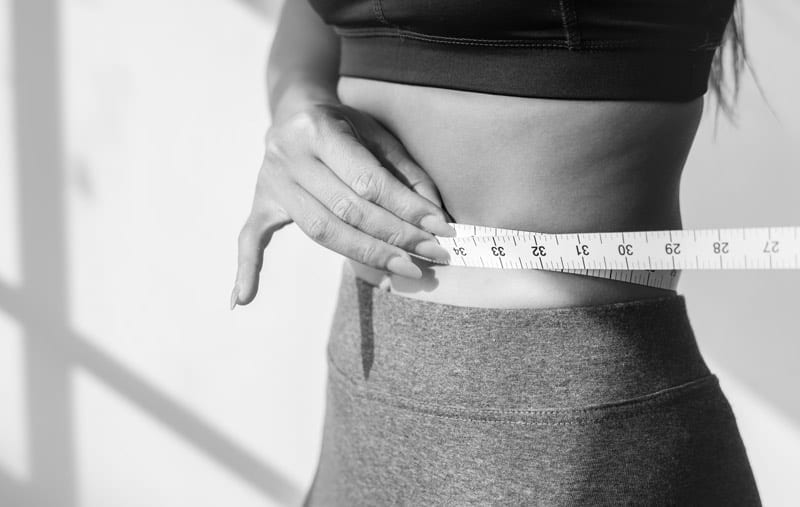 woman measuring waist