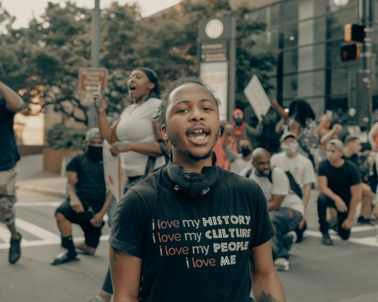 man in bipoc pride shirt