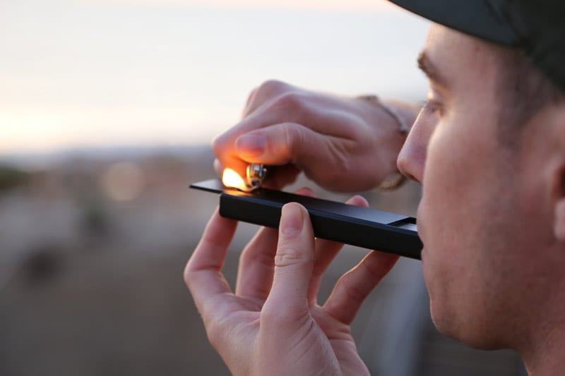 young man with cannabis pipe