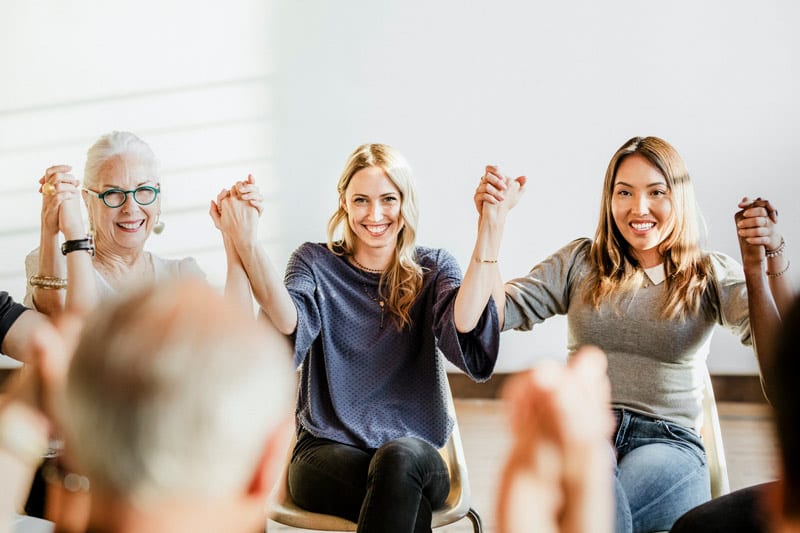 support group holding hands