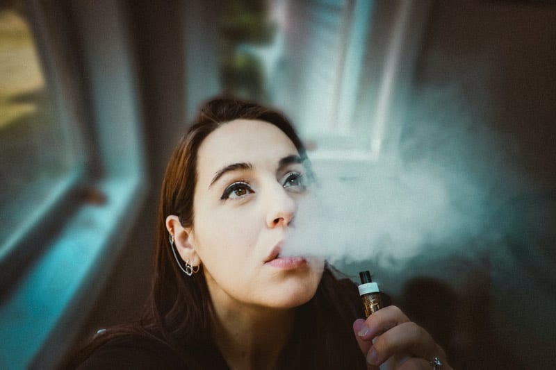 young woman vaping.