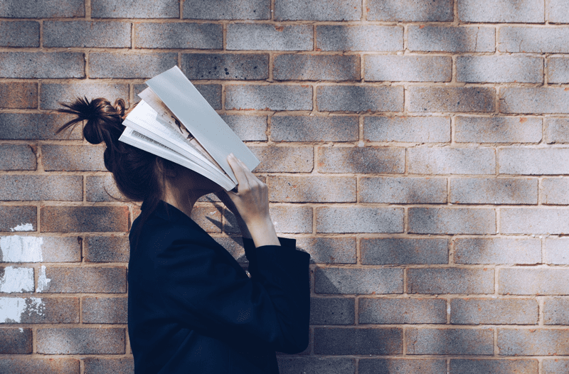 woman with head in book