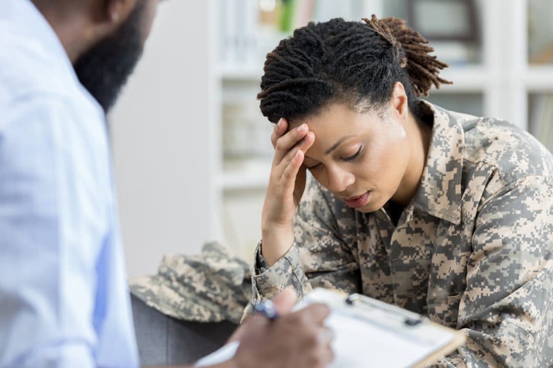 stressed woman in military fatigues
