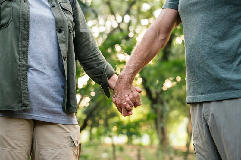 older couple holding hands