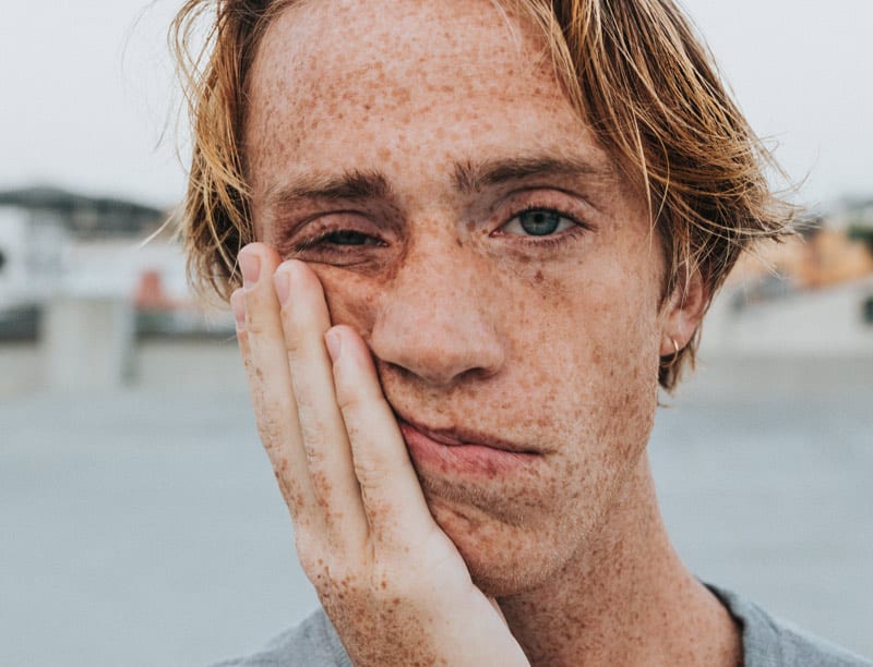 frustrated man with hand on face