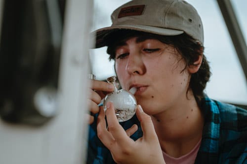 teen smoking bubbler pipe