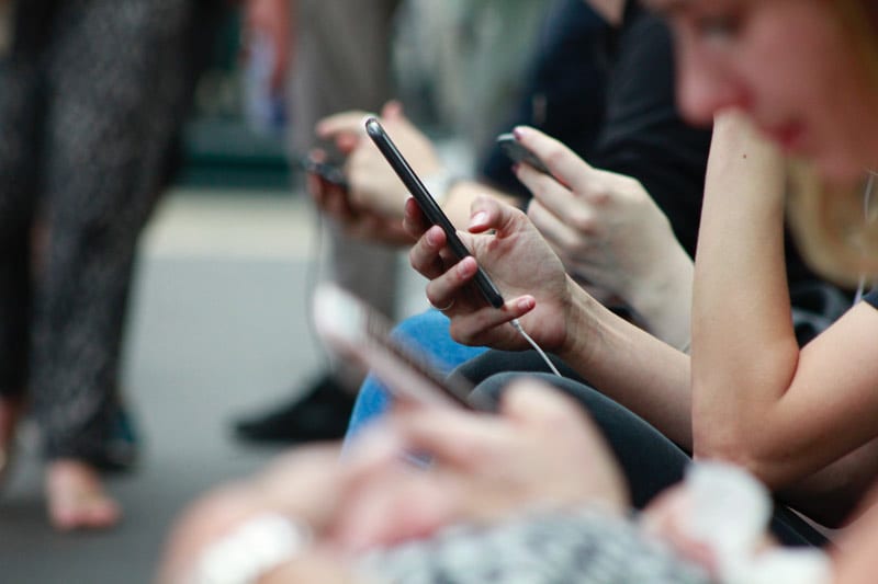 hands holding smartphones