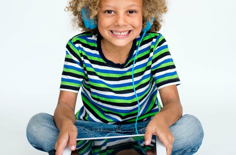 biracial kid with tablet