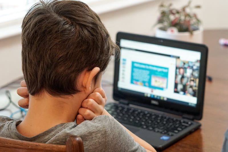 child with laptop in online school
