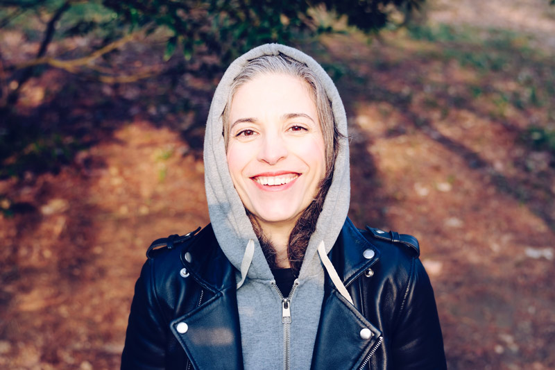 smiling woman in hoodie