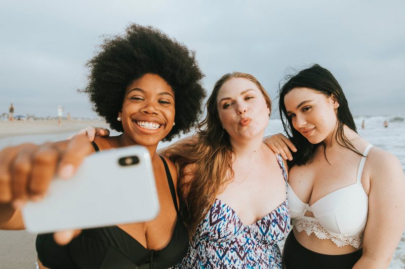 3 body-positive women at the beach