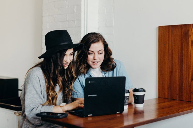 two young women at laptop