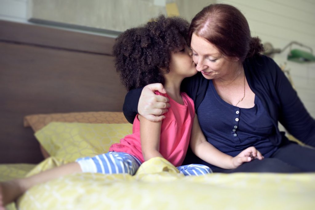 mother and daughter on bed