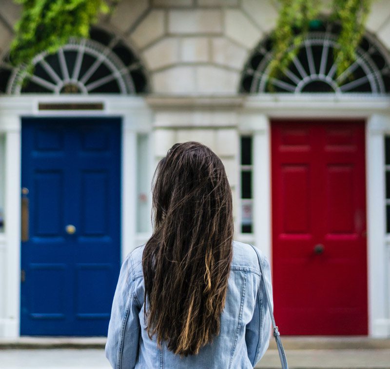 woman standing before two doors