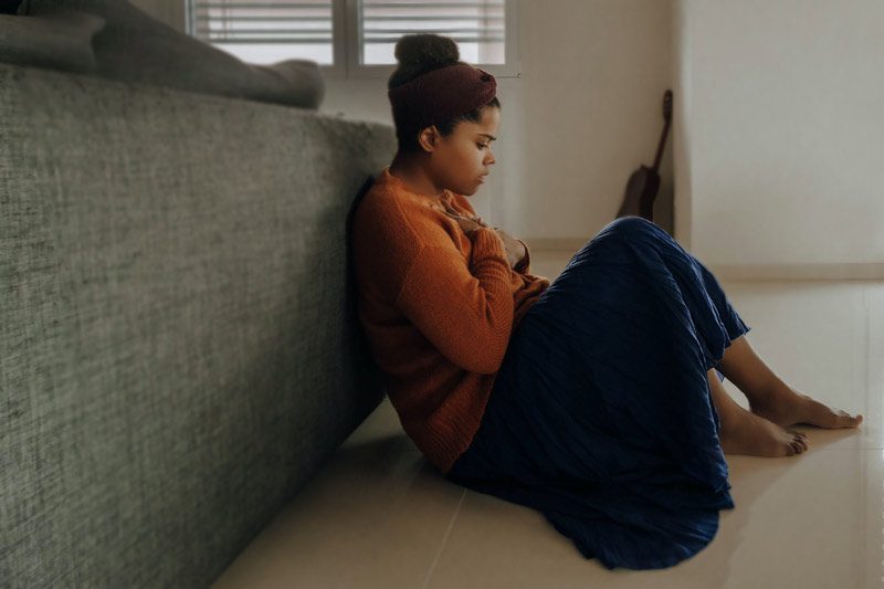 woman in orange on floor