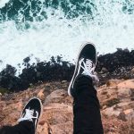 shoes hangin off cliff over ocean