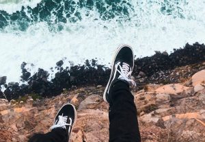 shoes hangin off cliff over ocean