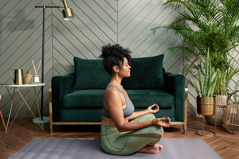 woman meditating in living room