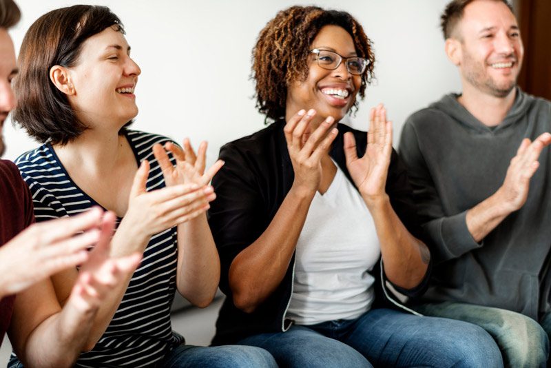 three friends clapping