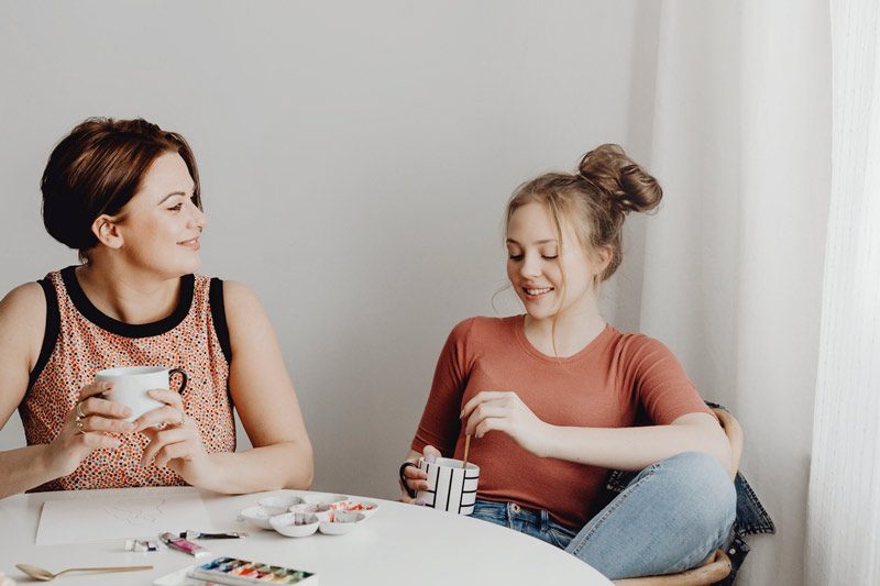 female friends take a break from art