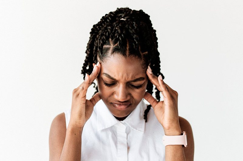 stressed woman with hands to head