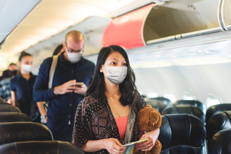 masked passengers boarding flight.