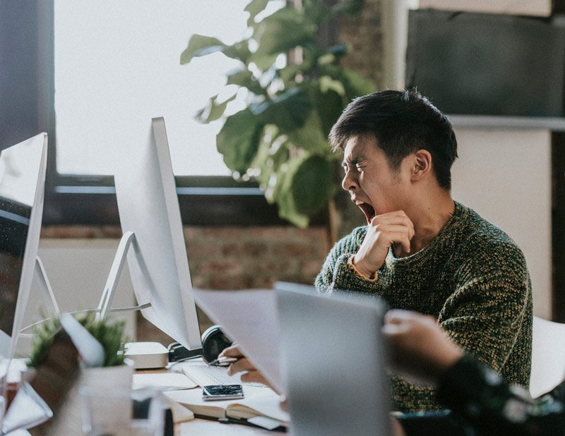 man yawning at work