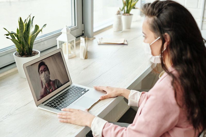 woman on video call on laptop