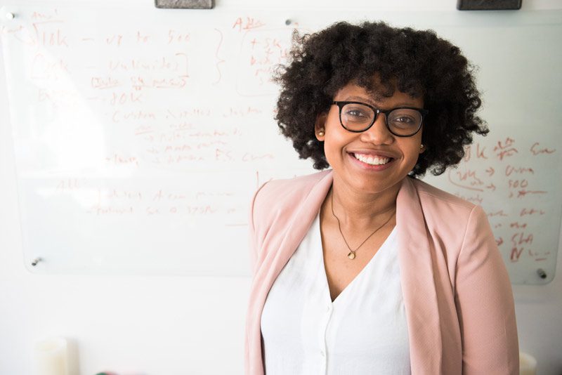 Black MD in front of whiteboard