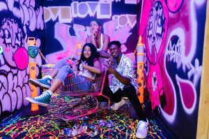 happy friends in day-glo room
