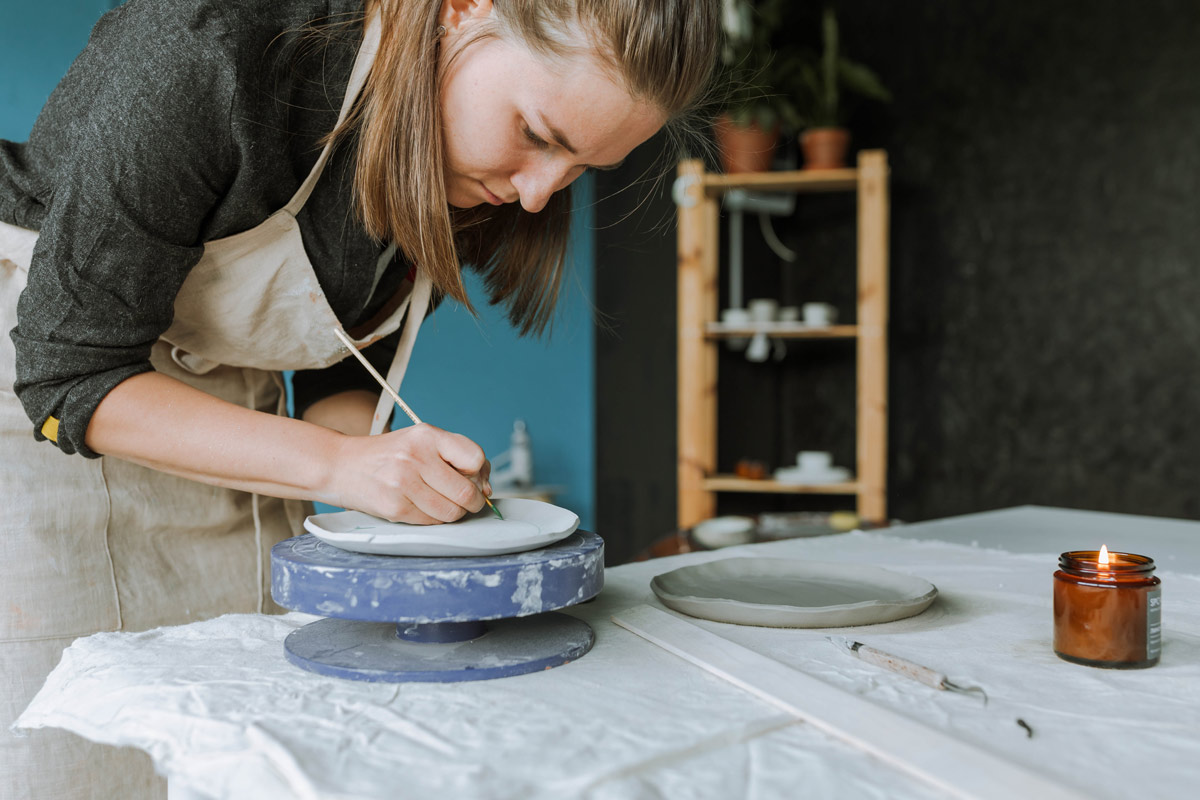 woman painting ceramics
