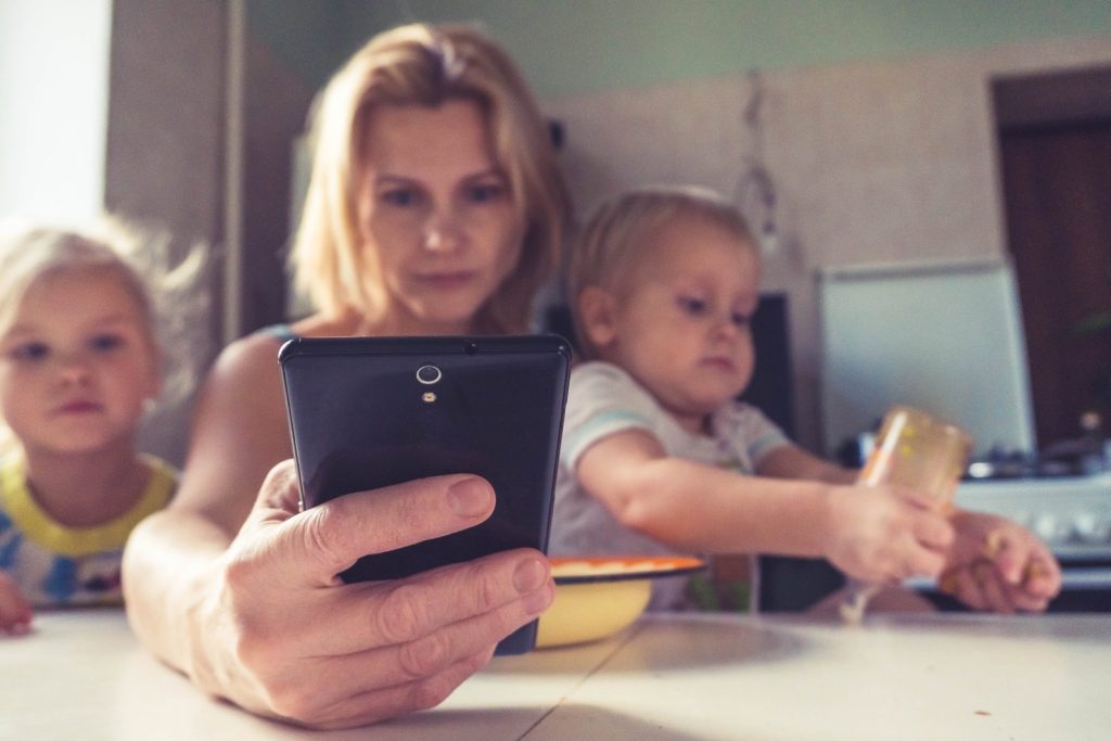 busy mother on phone with children