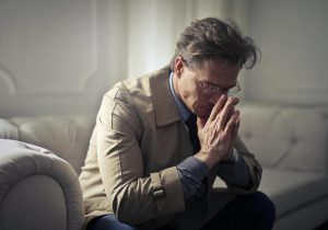 pensive man on couch