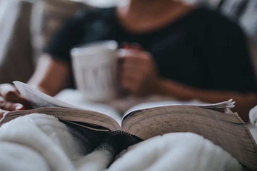 reading a book with a cup of coffee