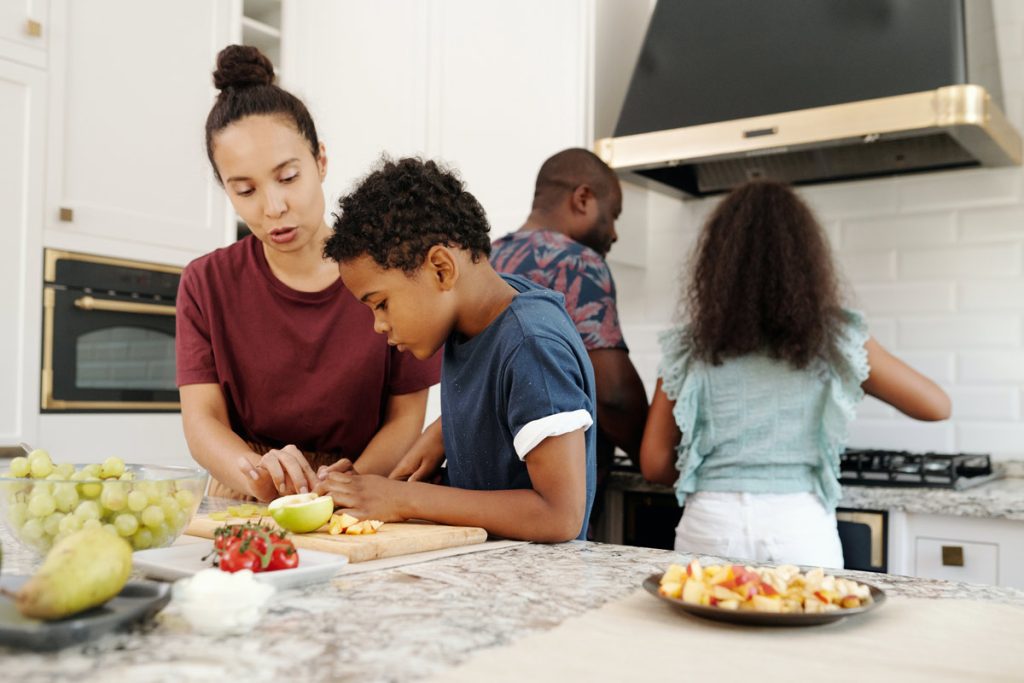 parents teaching kids to cook