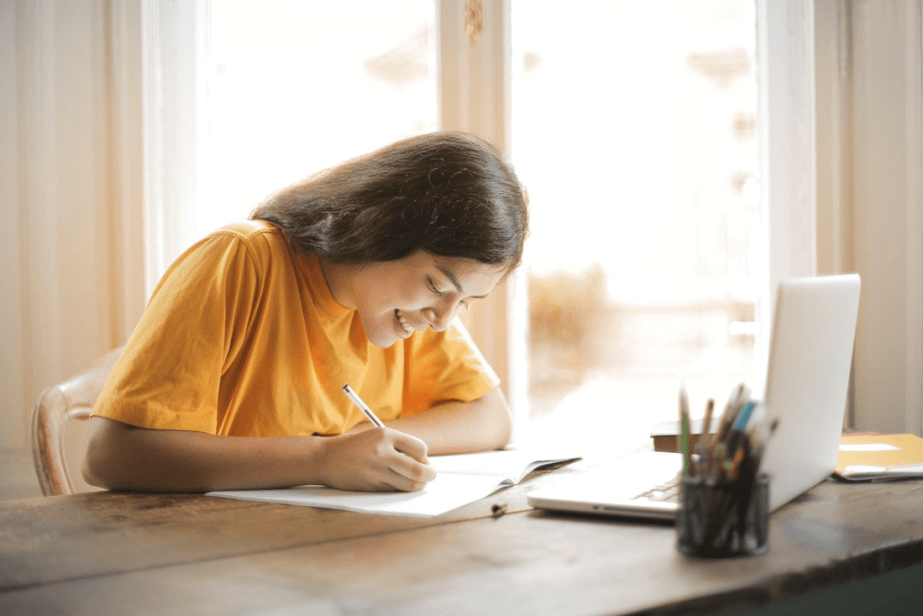 happy woman writing on paper.