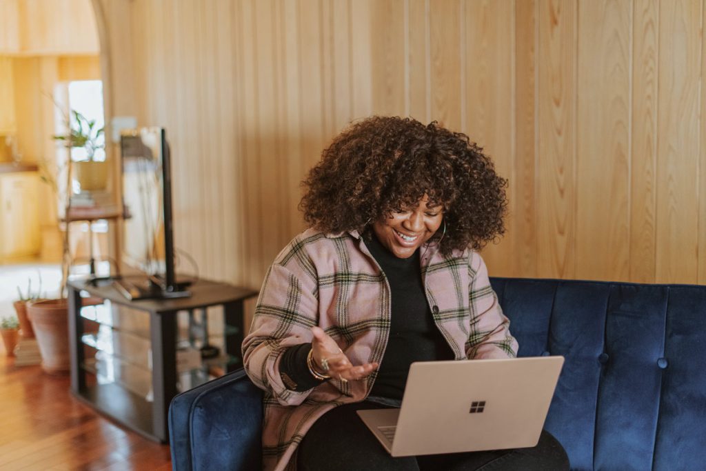 black woman on laptop video session