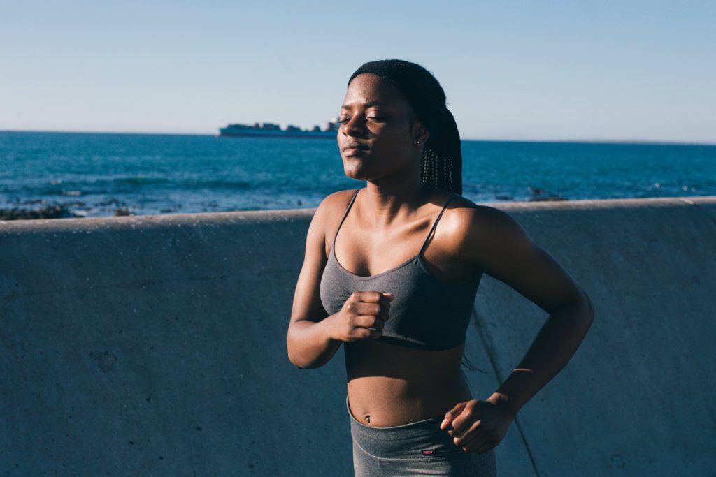 woman jogging near water