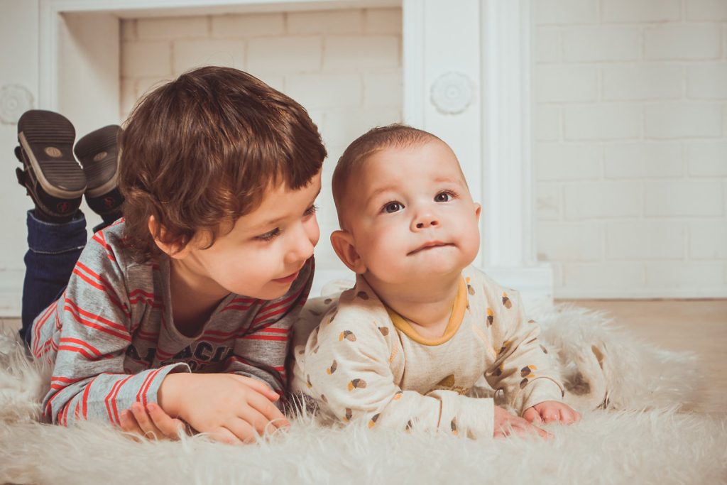 toddler with newborn sibling