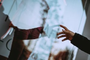 hand touching glass reflection