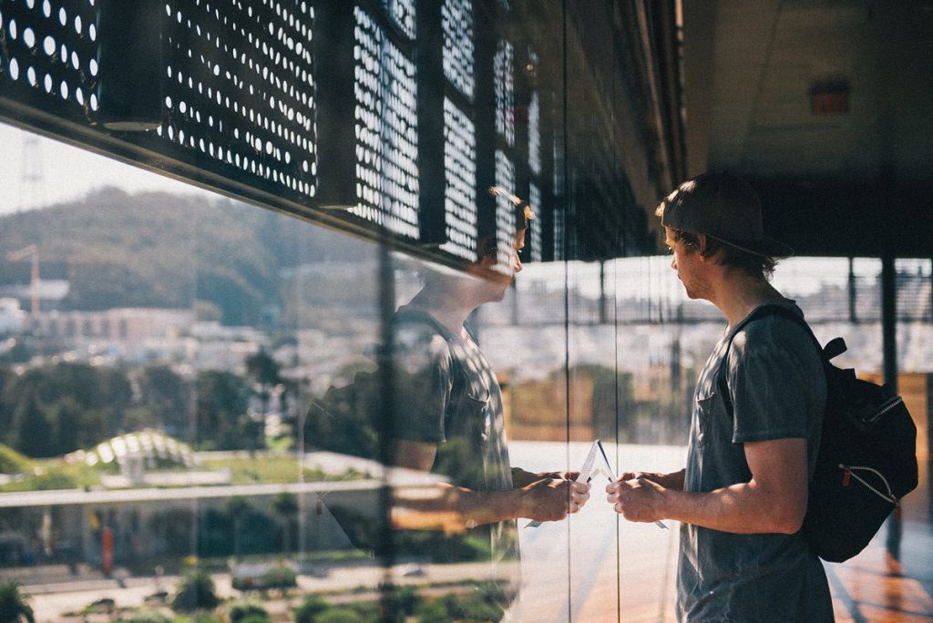 man standing in front of window