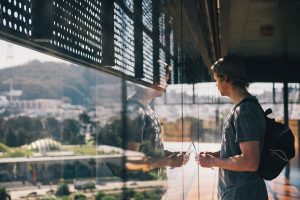man standing in front of window