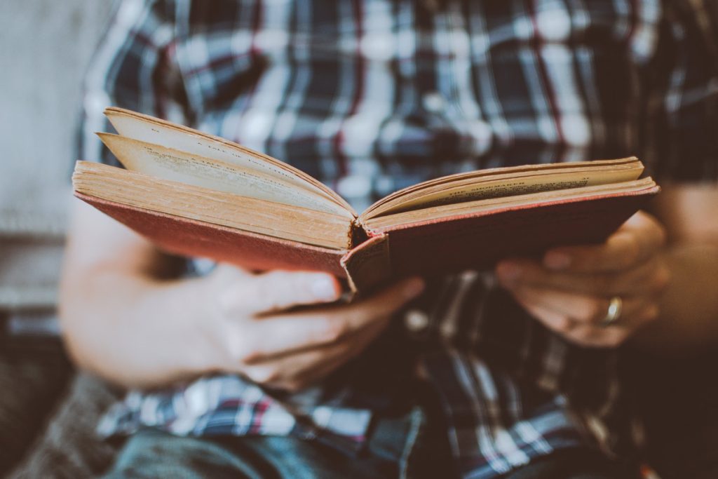 hands holding open book