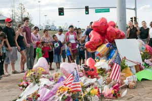 how to solve mental health issues of students Strangers hold hands at Aurora, CO memorial