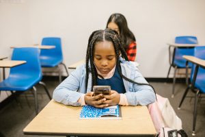 worried teen with smartphone