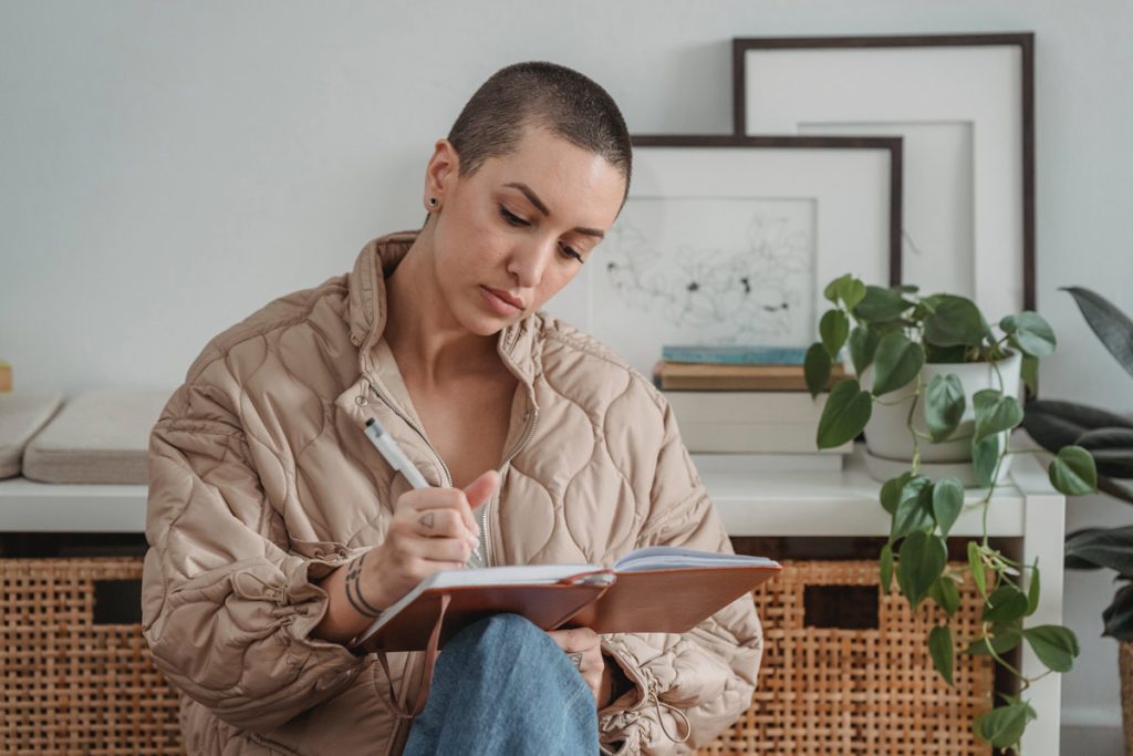 woman writing in notebook