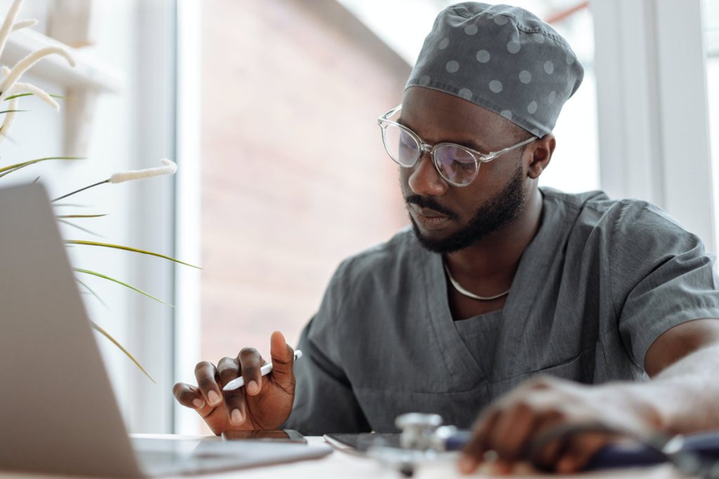 health professional at laptop