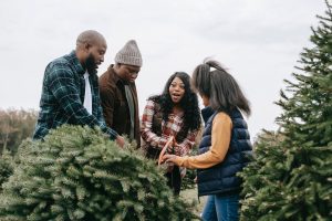Black family cutting Christmas tree